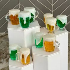 there are many mugs with beer on top of each other in the shape of cubes