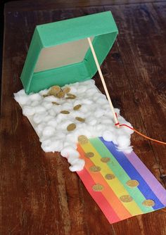 an open box with cotton and gold coins in it on top of a wooden table