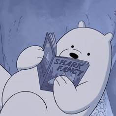 a polar bear reading a comic book in the snow