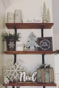 two wooden shelves with christmas decorations and candles on them, one shelf is decorated with snowflakes