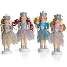 three little dolls with tiaras are standing next to each other