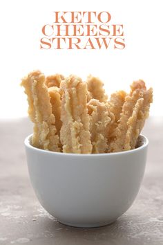 a bowl filled with keto cheese straws sitting on top of a white counter