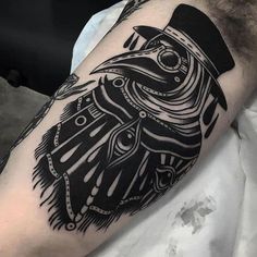 a black and white tattoo on the arm of a man