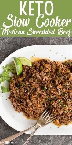 the keto slow cooker mexican shredded beef on a white plate with a fork