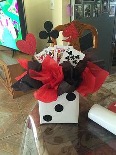 a white box filled with cards sitting on top of a table next to a tv