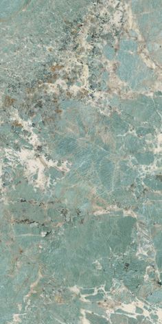 a green marble counter top with white and brown streaks on the surface is shown in close up