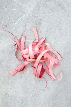 some pink ribbons are laying on the ground