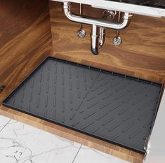 the floor mat is attached to the cabinet door and under the faucet in the bathroom