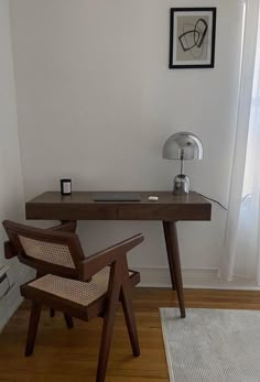 a chair and desk in a room with white walls