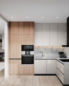 a modern kitchen with white cabinets and wood flooring