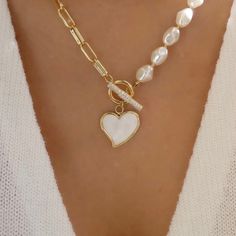 Introducing Our New Elegant 2023 Statement Piece “Heart Of Hearts” Pearl Necklace! This 18” lopsided Fresh Water Pearl & 14k Solid Gold Stainless Steal Heart shaped Charm Necklace encrusted with Flawless Chrystal’s and Clear Sapphire Gemstones On the Toggle Bar Clasp which gives this necklace a unique Uneven Half & Half never before seen Unique Design. This Necklace lets off the most beautiful Bright sparkles with every movement in every light making this necklace the statement piece of the deca Luxury Pearl Necklace With Pearl Charm For Festivities, Luxury Heart Beads Necklace For Valentine's Day, Heart-shaped Pearl Charm Jewelry, Elegant Heart Necklace With Toggle Clasp, Heart Shaped Jewelry With Toggle Clasp For Anniversary, Valentine's Day Heart Pendant Jewelry With Toggle Clasp, Valentine's Day Jewelry With Toggle Clasp, Pearl Heart Necklace, Bridal Events