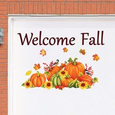 a welcome fall sign with pumpkins and sunflowers