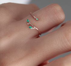 Shop our beautiful Original 925 Silver two green Ivy Olive Shaped Leaf Ring on Etsy. This dainty and elegant ring is handmade with love and care, featuring a unique olive tree design. Wear it as a symbol of protection against the evil eye, or simply as a stylish accessory for everyday wear. This stackable ring makes a perfect gift for birthdays, Christmas, or for your best friend. Invest in your beauty and add this handmade leaf design tree branch ring to your jewelry collection today! Find the perfect gift for your loved one with our minimalist heart shape infinity necklace. This elegant piece of jewelry is a symbol of eternal love and makes a great Valentine's Day or anniversary present. Add a touch of romance to your outfit with this beautiful necklace, handmade with care and attention Fine Jewelry Flower Ring For May Birthstone, Rose Gold Emerald Open Ring Gift, Green Open Ring Jewelry For Gift, Rose Gold Emerald Ring Gift, Delicate Green Sterling Silver Jewelry, Nature-inspired Ring With May Birthstone For Gift, Dainty Sterling Silver Emerald Ring, Green Open Ring For Promise, Green May Birthstone Flower Ring In Fine Jewelry