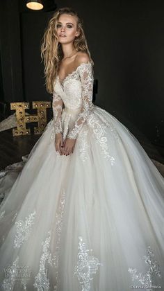 a woman in a white wedding dress posing for the camera with her hands on her hips