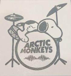 the logo for arctic monkeys is shown on a white paper with an image of a man playing drums