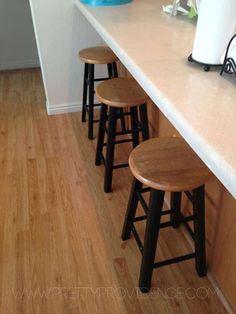 three stools sitting on top of a counter in a kitchen