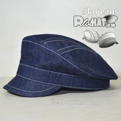 a blue hat with white stitching on the front and side, sitting on top of a table