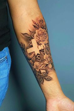 a person with a cross and flowers on their arm