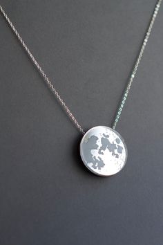 * Full Moon Necklace * The full moon is made with silver mirror acrylic, while its craters are laser engraved and then filled by hand. This is perfect for minimalists as it's a very discreet yet very charming design. The necklace is incredibly lightweight and comfortable to wear. - Hypoallergenic; - Chain: Silver colour, 45 cm; - Weight: 7 grams (with chain); - Dimensions: 3.5 cm - Engraved; - Handcrafted in England in our studio; - All our products are aesthetically and eco-friendly packed and Romantic Minimalist, Full Moon Necklace, Hypoallergenic Necklace, Mirror Acrylic, Silver Mirror, Chain Silver, Silver Colour, Moon Necklace, Silver Mirrors