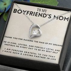 a necklace with a heart on it in a box