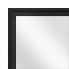 a black framed mirror on a white wall with an empty space for the image to be taken