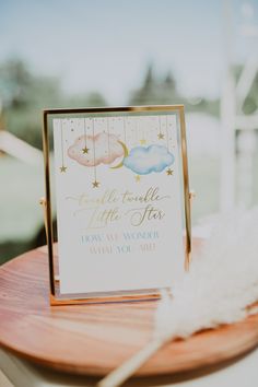 there is a card on top of a wooden table with a white feather in the foreground