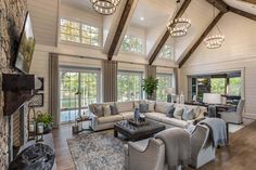 a living room filled with lots of furniture next to a fire place in a house