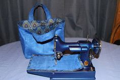 a blue bag sitting on top of a table next to an old fashioned sewing machine