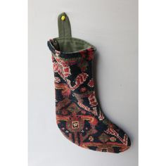 a stocking hanging on the wall with an ornament