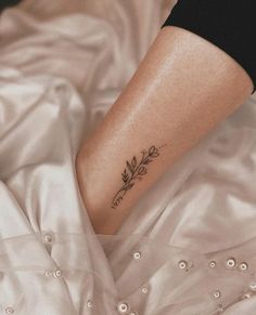 a woman's foot with a flower tattoo on it