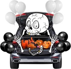 a car with halloween decorations and balloons in the trunk