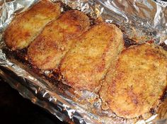 four pieces of fried food sitting on top of tin foil