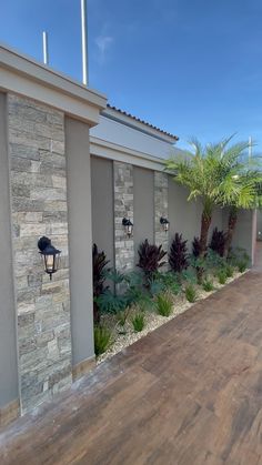 an outside view of a house with wood flooring and plants on the side of it