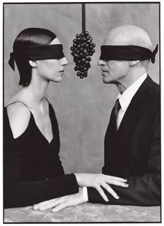 a man and woman wearing blindfolds are facing each other