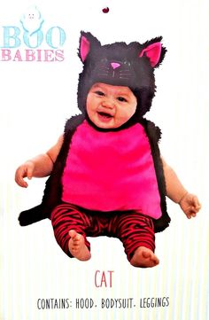 a baby wearing a cat costume on top of a card