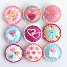 nine small cupcakes are decorated with hearts and other things to decorate on them