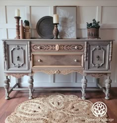 an old dresser is painted gray and has ornate carvings on the top, along with other antique furniture