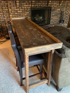 a wooden table sitting in front of a fire place