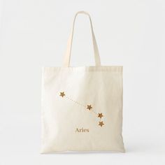 a tote bag with stars on it and the word aris written in gold