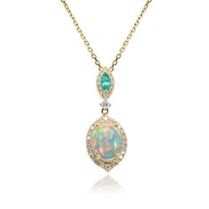 Fall in love with the scintillating shimmer of this opal, emerald and diamond pendant. In precious 10K yellow gold, one oval opal offers iridescent charm and mystery. A marquise shaped emerald offers lush optimism. Each of these gemstones is surrounded and linked by 37 total round single cut diamonds for dazzling glimmer and flirtatious sparkle. | 1/5 ct. tw. Opal, Emerald & Diamond Pendant Necklace | 10K Yellow Gold | Size 18" | Helzberg Diamonds Bolder Opal Necklace, Opal Accessories, Emerald Diamond Pendant, White Sapphire Necklace, Helzberg Diamonds, Lab Created Emerald, Choker Pendant, Diamond Solitaire Necklace, Sapphire Necklace