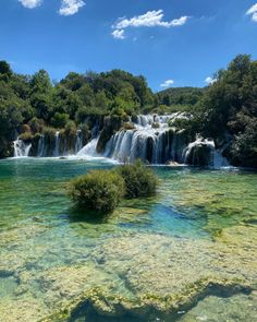 the water is crystal green and there are many small waterfalls in the middle of it