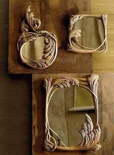 two mirrors are sitting on top of a piece of wood