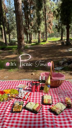 a picnic table with food on it in the middle of some trees and an advertisement for picnic time