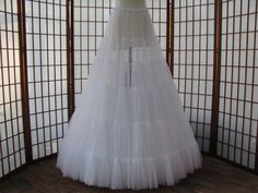 "The pictured petticoat was a custom order for a bride who decided to wear it as the skirt in her wedding outfit instead of as a petticoat -- see last two photos ;) This sale is for a custom version of the pictured white single layer petticoat/skirt made out of soft nylon chiffon. The waist will be .75\" (2cm) wide elastic that will be covered by satin charmeuse for comfort. Sizing is based on HIP circumference, not waist circumference, although I will need your waist measurement also. The hip m Cheap Stretch Tulle Petticoat, Cheap White Crinoline Petticoat, Cheap Spring Petticoat Skirt, Cheap Tulle Petticoat For Dance, Cheap Dance Tulle Petticoat, Cheap White Stretch Petticoat, Cheap Hardwood Floors, Glass Flooring, Tulle Petticoat