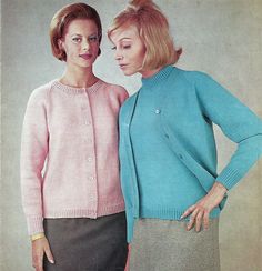 two women standing next to each other wearing sweaters