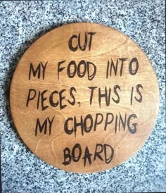 a wooden sign that says cut my food into pieces, this is my chopping board