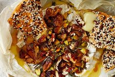 a bowl filled with food sitting on top of a wooden table and covered in paper