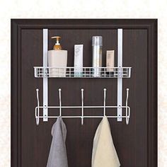 a bathroom shelf with two towel racks and one hanging on the wall next to it