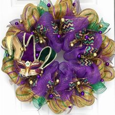 a purple and green wreath with mardi gras decorations