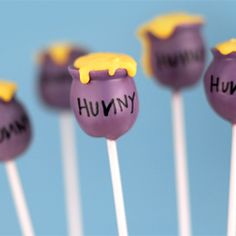 purple and yellow candy lollipops with the word hummy written on them